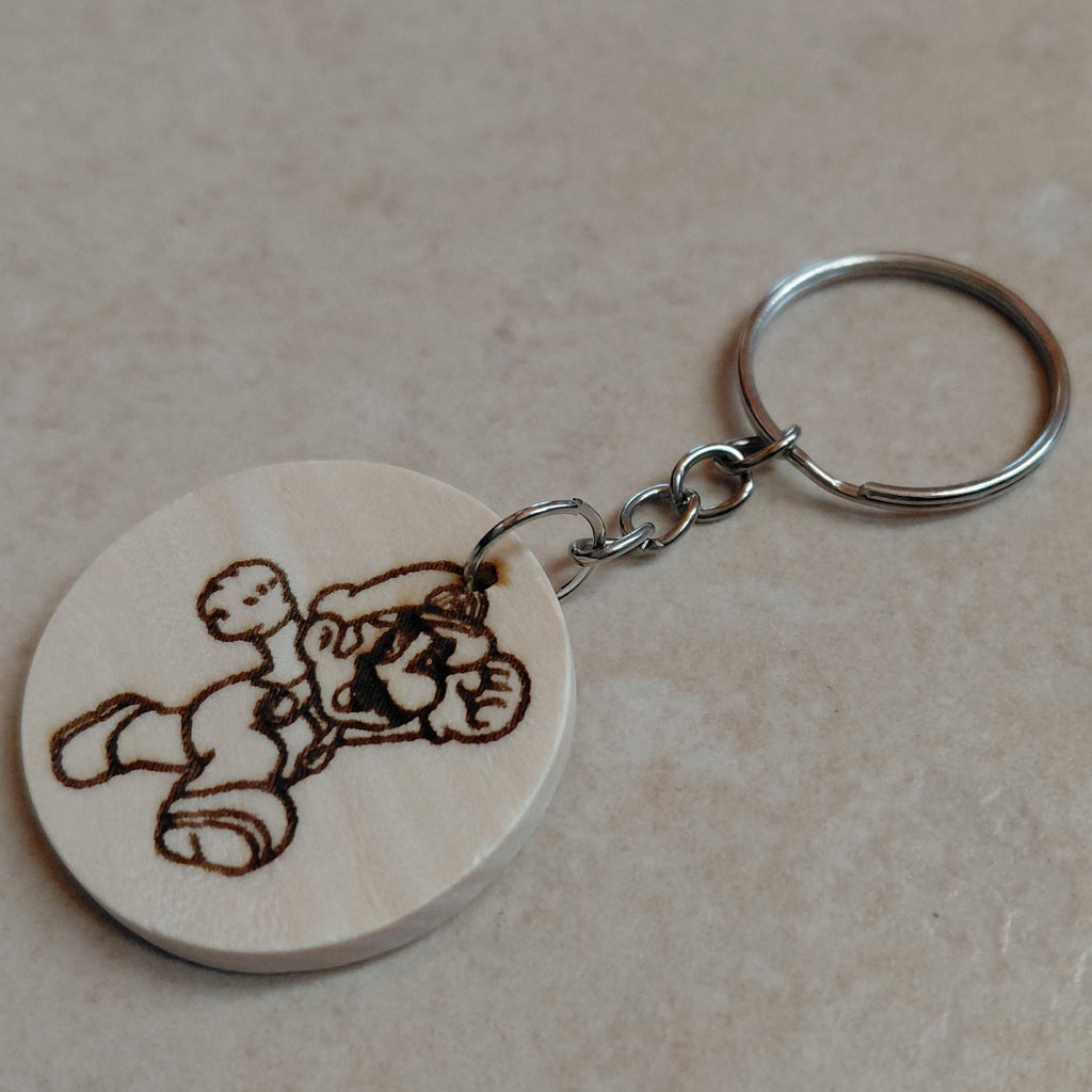 Llavero artesano de madera grabado a láser con la imagen de Super Mario Bros