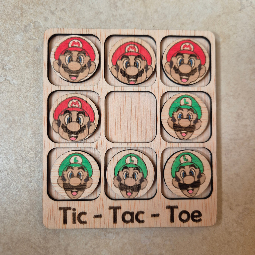 Hermoso juego de Tic-Tac-Toe (Tres en raya) artesanal, elaborado en madera natural mediante técnica de corte y grabado láser, y pintado completamente a mano con gran detalle y cuidado.

Incluye fichas ilustradas con los famosos personajes de Super Mario Bros (Mario y Luigi), lo que lo convierte en un artículo único, colorido y lleno de encanto, ideal tanto para jugar como para decorar.

Perfecto como regalo original, recuerdo artesanal o elemento decorativo para habitaciones infantiles, escritorios o estant